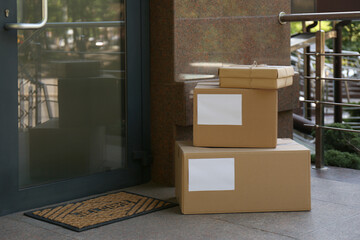 Fototapeta na wymiar Delivered parcels on porch near front door