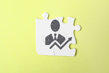 Business development concept. White puzzle pieces on yellow background, top view