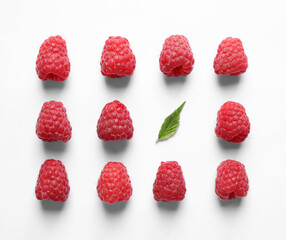 Fresh sweet ripe raspberries on white background, flat lay