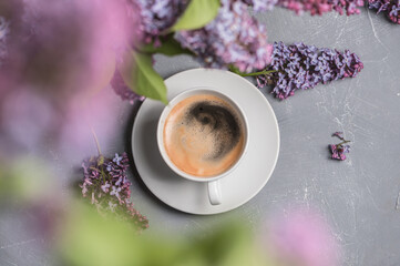 Obraz na płótnie Canvas Cup of coffee on light background with lilac