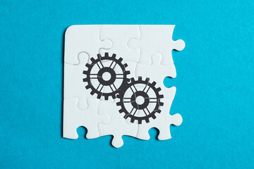 Teamwork concept. White puzzle pieces on turquoise background, top view