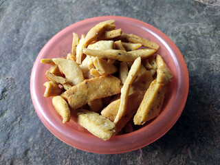 some yellow fresh eatable food put in a bowl on stone background