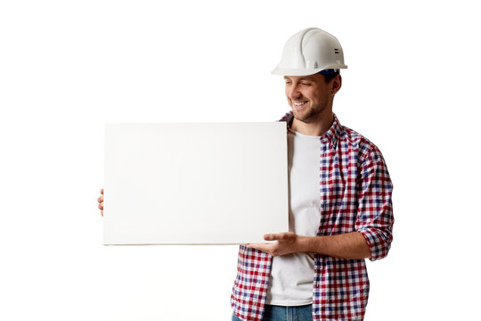 smiling handyman worker in hard hat holding empty blank board. builder in shirt isolated on white studio background - Powered by Adobe