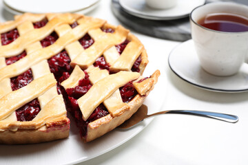 Delicious fresh cherry pie on white table, closeup