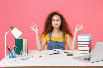 Young african american girl employee in office isolated on pink background. Achievement business career. Education in school university college concept. Hold hands in yoga gesture relaxing meditating.