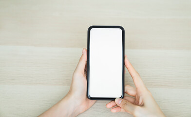 Woman hand holding smartphone and touching blank screen. Mockup of advertisement.