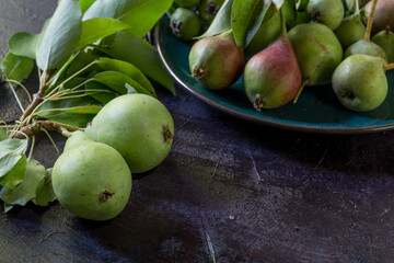 pears on the plate on an aged table