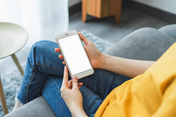 Woman hand holding smartphone and touching blank screen. Mockup of advertisement.