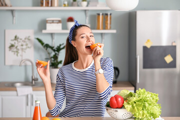 Beautiful young woman with fresh products in kitchen