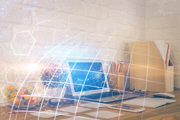Double exposure of desktop with computer and world map hologram. International data network concept.
