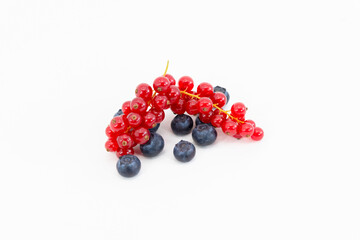 a bunch of delicious looking red currant on top of a few blackberries. Berries and vegan food concept.