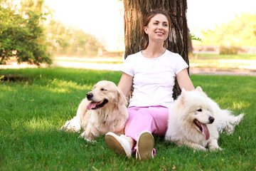 Young woman with cute dogs in park
