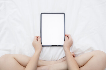 Top View of Woman Watching Her Blank Tablet with Empty Space on the Bed