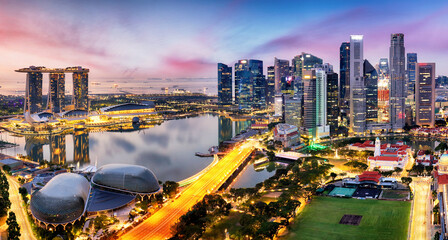 Skyscrapers of Singapore skyline at the beautiful sunset, aerial panorama - obrazy, fototapety, plakaty
