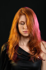 Naklejka premium Beautiful young redhead woman on dark background