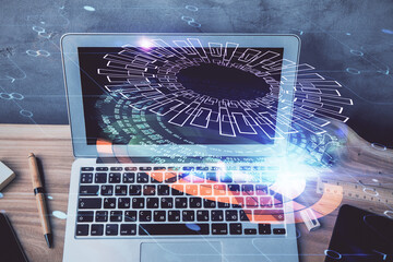 Double exposure of desktop computer and technology theme hologram. Concept of software development.