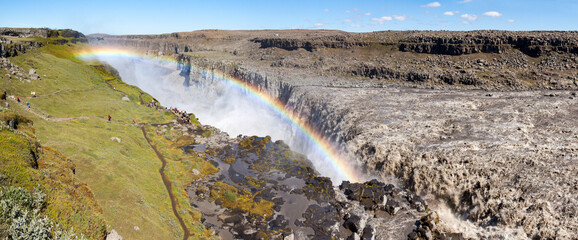Rainbow over Dettifoss, Europe's largest waterfall; sediments give the water a similar gray color as the volcanic rocky surroundings.