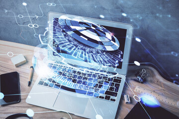 Double exposure of desktop computer and technology theme hologram. Concept of software development.