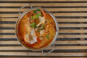 Tom Yum kung on hot pot, Spicy Sour Soup with herb and giant freshwater prawn, Thai traditional food, thailand
