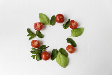 Naklejka na ściany i meble Composition of tomato, basil and mint with a place for an inscription in the center.