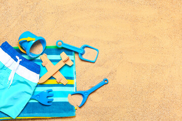 Set of beach accessories for children on sand, top view