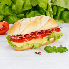 Sub sandwich with salami ham and cheese square on wooden board