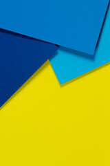 Abstract color papers geometry flat lay composition background with blue and yellow tones