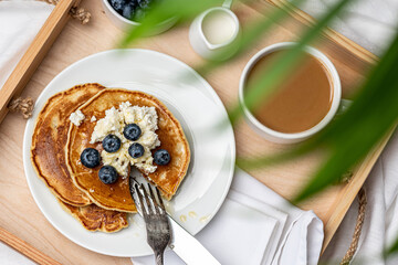 
Delicious freshly prepared breakfast on a wooden tray. Top view.