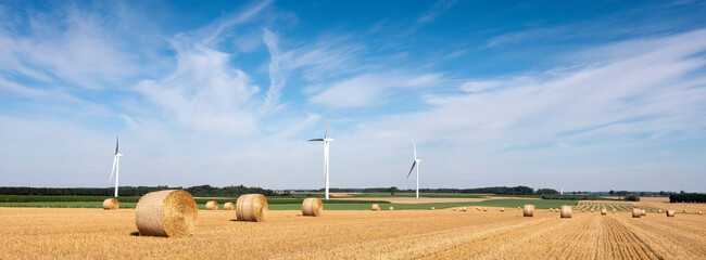 fields and wind turbine in the north of france under blue sky
