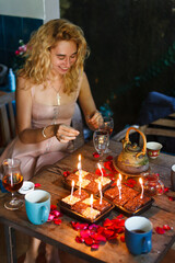 Portrait of a blonde girl at a festive table on a birthday