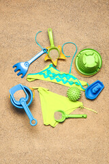 Set of beach accessories for children on sand, top view