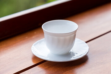 empty white coffee cup  or tea cup on wood table. 