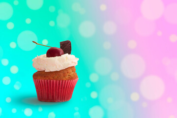 Delicious cupcake with colorful blurred lights background