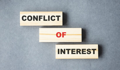 conflict of interest text from wooden blocks on desk