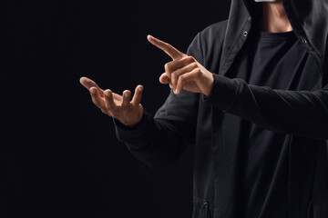 Professional hacker using virtual screen on dark background