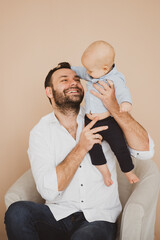 Obraz na płótnie Canvas Happy father holding little baby son. Fatherhood concept