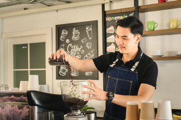 The young barista is determined to make coffee meticulously.