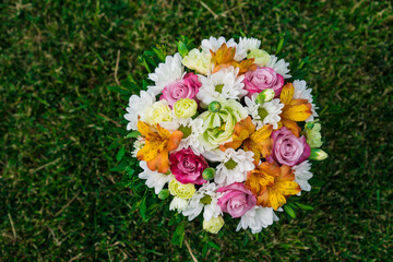 bouquet of colorful flowers on green lawn. place for text.