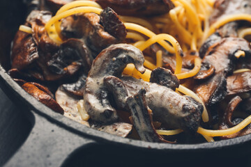 Frying pan with tasty pasta and mushrooms, closeup