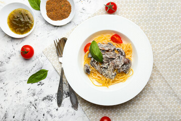 Plate with tasty pasta and mushrooms on white background