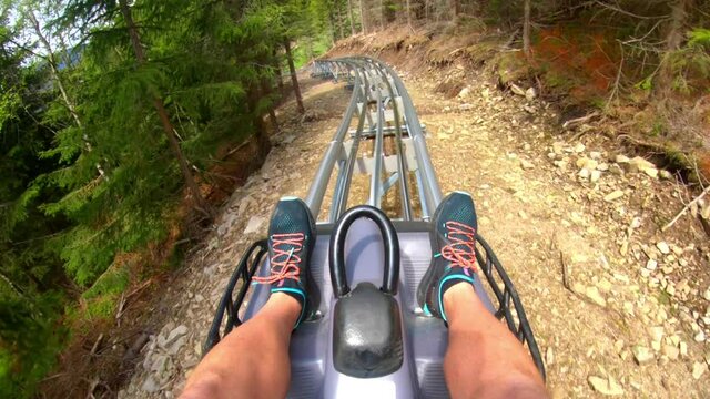 POV GoPro Shot Of A Man Riding Fast On An Extreme Outdoor Roller Coaster In The Middle Of A Forest In The Mountains Of Dolní Morava, Czech Republic. Mamutí Horská Dráha In The Mountains Of Czechia.