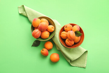 Tasty ripe apricots on color background