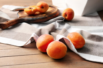 Tasty ripe apricots on table