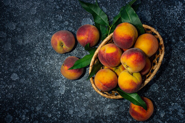 Peaches in a basket on the table. View from above.
