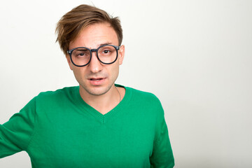 Portrait of nerd man with blond hair wearing eyeglasses