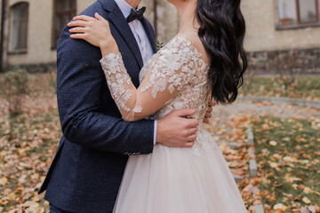 bride and groom in an autumn park at a wedding