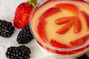 Mousse dessert with berry topping on grey surface