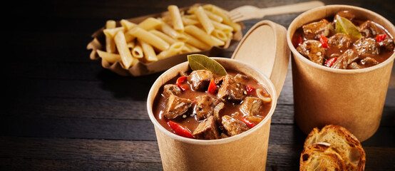 Double serving of takeaway beef goulash in tubs