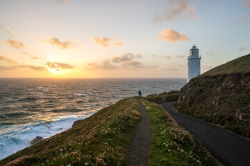 Naklejka premium Trevose Head, Cornwall, UK. Lighthouse and hiker