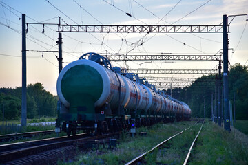 Transport tank car LNG by rail, gas - oil products. LPG transport propane. The fuel train, rolling stock with petrochemical tank cars. Liquefied natural gas export. Soft focus, object in motion.